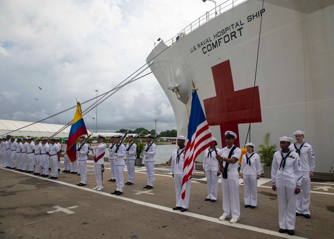 CARTAGENA, Colombia (Nov. 18, 2022) Sailors attached to hospital ship USNS Comfort (T-AH 20) and the Colombian navy present their nation's flags during a closing ceremony signaling the end of the Colombia portion of Continuing Promise 2022 on the pier next to Comfort, Nov. 18, 2022.