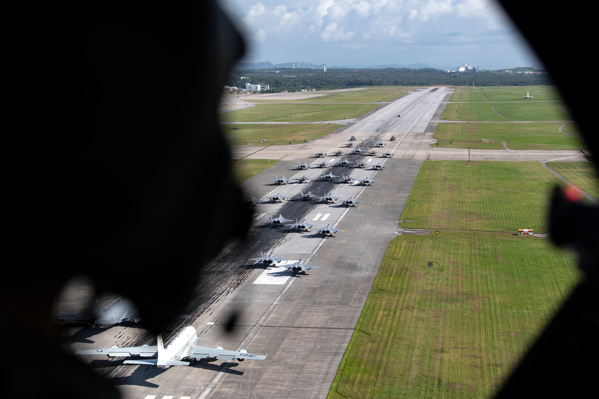 U.S. Air Force aircraft line up on the runway for a capabilities demonstration at Kadena Air Base, Japan, Nov. 22, 2022. The demo included HH-60G Pave Hawks, F-15C Eagles, F-22A Raptors, a KC-135 Stratotanker, an E-3 Sentry and an RC-135 Rivet Joint. (U.S. Air Force photo by Senior Airman Jessi Roth)