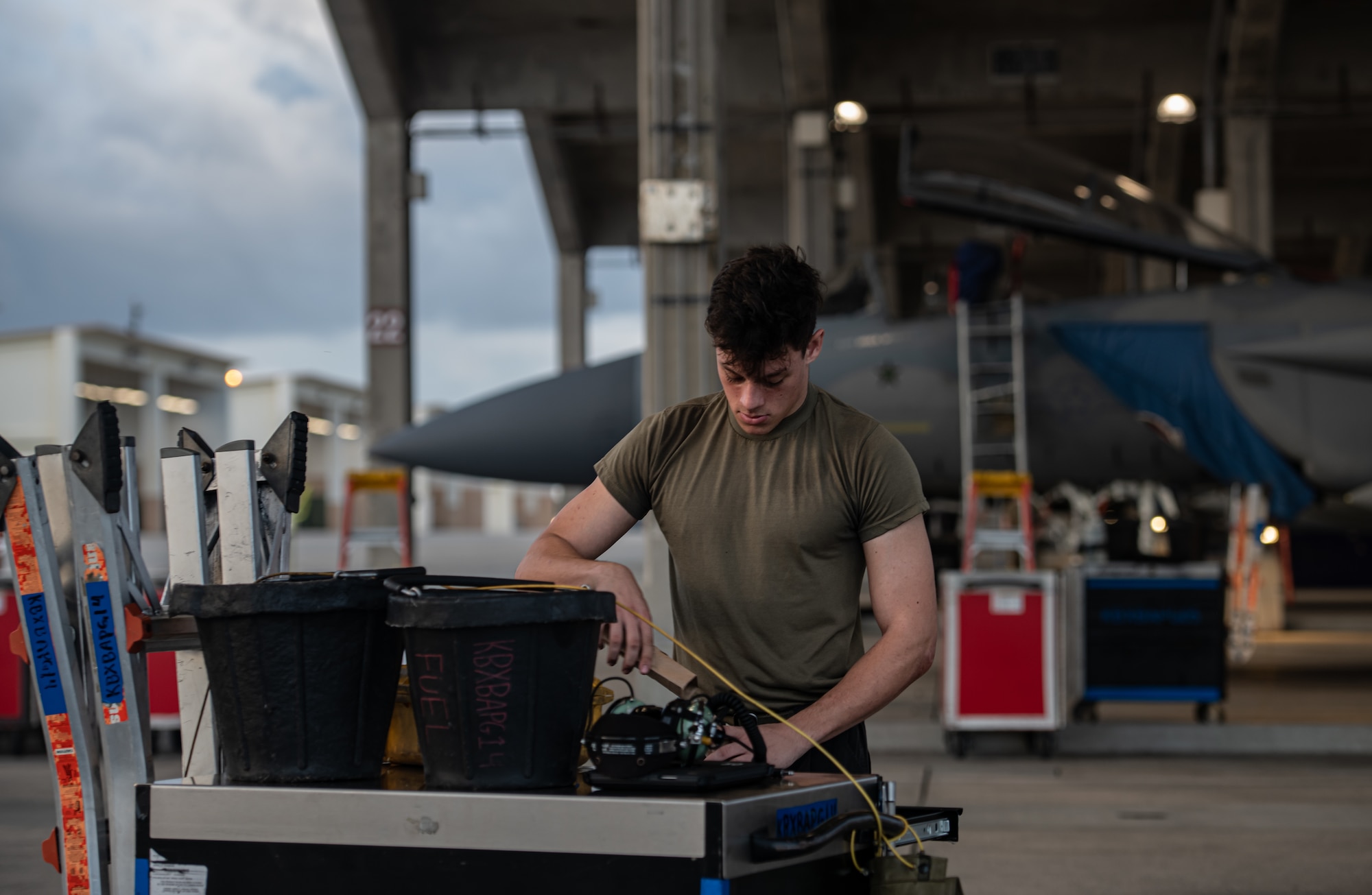 An Airman gathers tools in preparation to launch an F-15C Eagle.