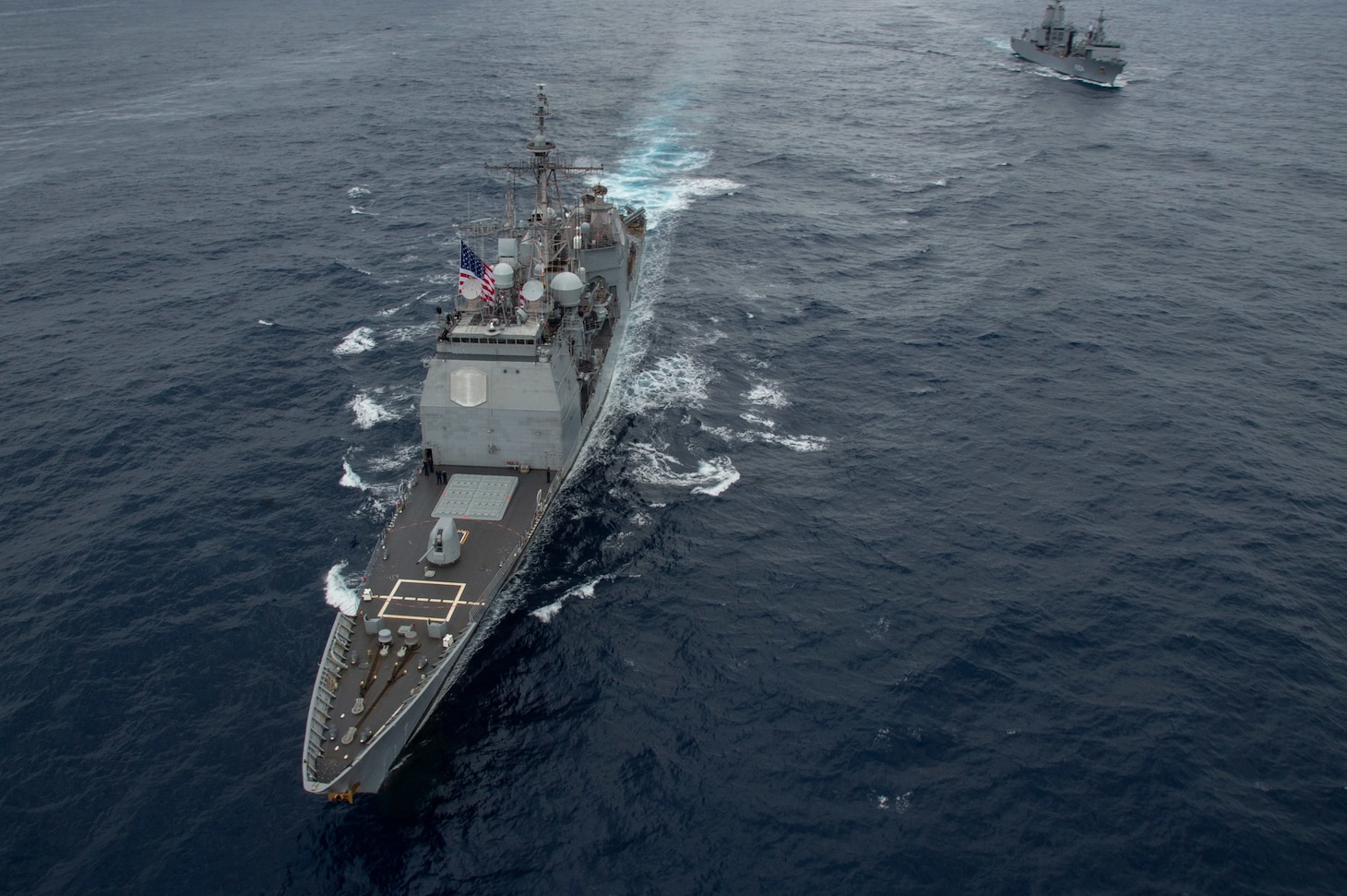 PHILIPPINE SEA (Nov. 20, 2022) The Ticonderoga-class guided-missile cruiser, USS Chancellorsville (CG 62), steams in formation with Royal Australian Navy supply ship, HMAS Stalwart (A304), in the Philippine Sea, Nov. 20. USS Ronald Reagan (CVN 76), the flagship of Carrier Strike Group 5, provides a combat-ready force that protects and defends the United States, and supports Alliances, partnerships and collective maritime interests in the Indo-Pacific region. (U.S. Navy photo by Mass Communication Specialist Seaman Heather McGee)