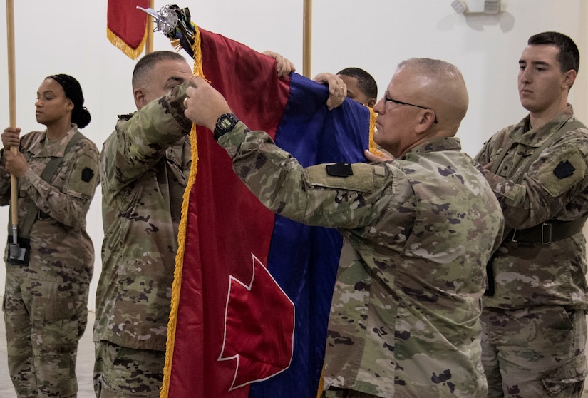 (left to right) Maj. Gen. Mark McCormack and Command Sgt. Maj. Randall Pritts, commanding general and command sergeant major, respectively, of the 28th Infantry Division, uncase the colors of the 28th ID during the Task Force Spartan transfer of authority on Nov. 20, 2022. The 28th ID took over the mission from the 35th ID (U.S. Army photo by Master Sgt. Matthew Keeler)