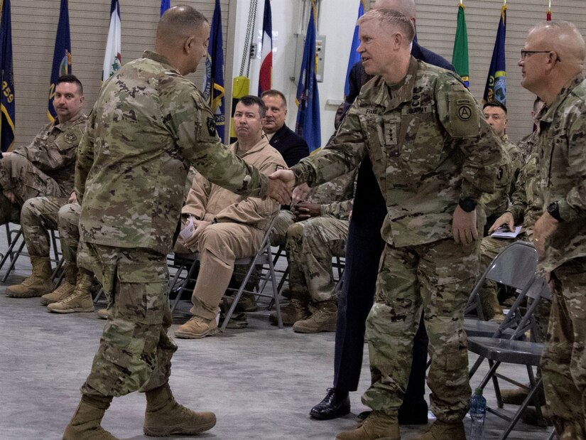 (Left) Maj. Gen. Mark McCormack, commanding general of the 28th Infantry Division, shakes hands with Lt. Gen. Patrick D. Frank, commanding general of U.S. Army Central, during the Task Force Spartan transfer of authority on Nov. 20, 2022. The ceremony honored the transition of the mission from the 35th ID to the 28th ID (U.S. Army photo by Master Sgt. Matthew Keeler).