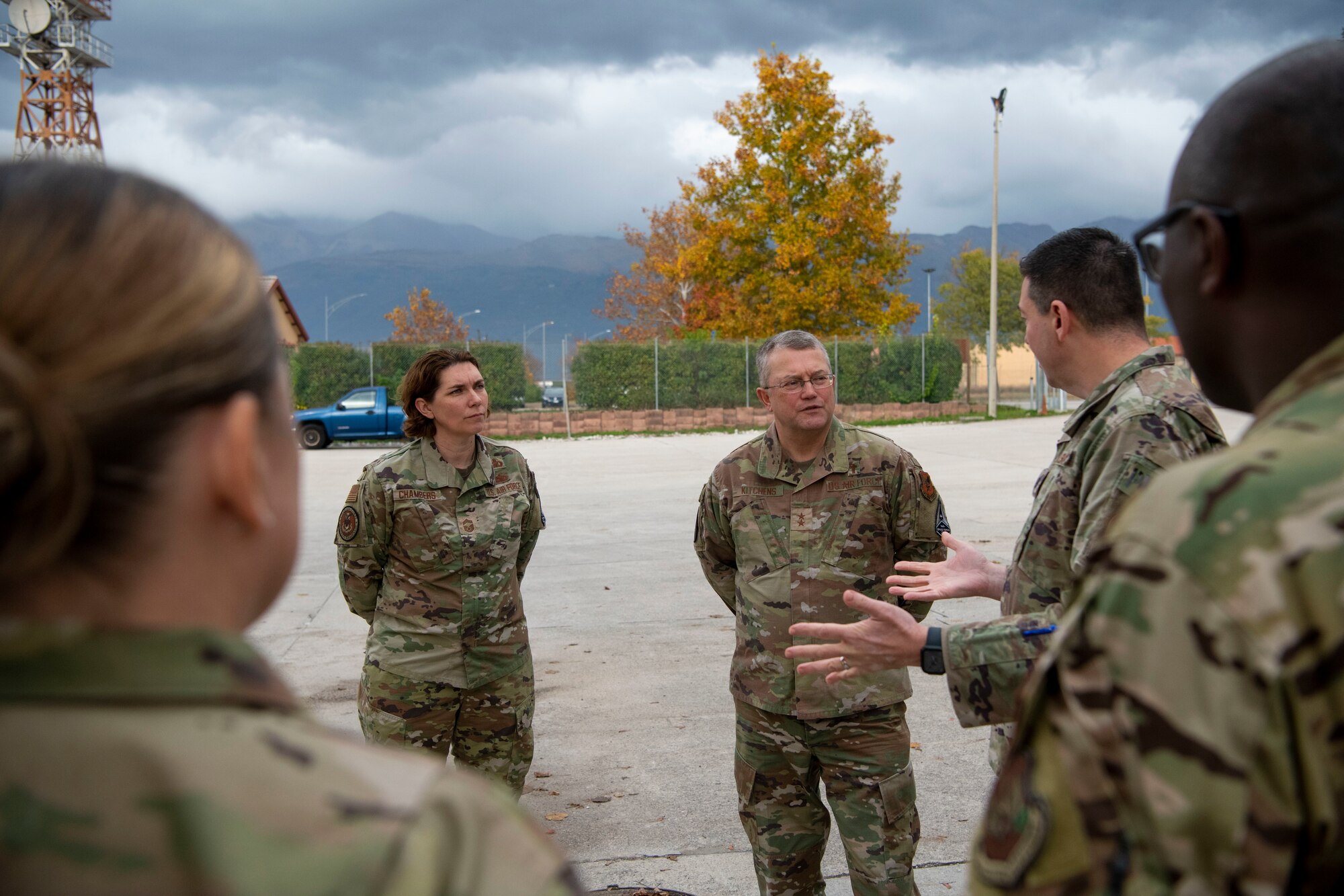 Chaplain (Maj. Gen.) Randall Kitchens, U.S. Air Force chief of chaplains, middle, and Chief Master Sgt. Sadie Chambers, U.S. Air Force religious affairs career field manager, left, are briefed by Lt Col. Joseph Faraone, 606th Air Combat Squadron commander, right, at Aviano Air Base, Italy, Nov. 18, 2022. Faraone explained the 606th ACS leadership’s prioritization of creating a positive, safe environment for Airmen’s well-being and morale. (U.S. Air Force photo by Airman 1st Class Thomas Calopedis)
