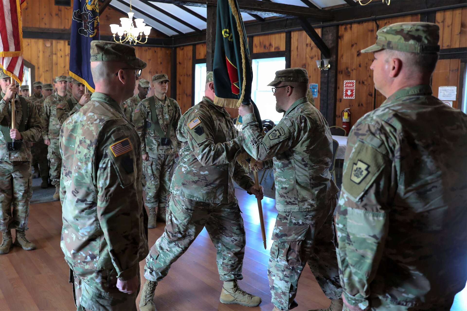 Lt. Col. Kevin Potts assumes command of the Fort Indiantown Gap National Guard Training Center, Pennsylvania Army National Guard, from Lt. Col. Andrew O’Connor at a change-of-command ceremony Nov. 19. Brig. Gen. James McCormack, assistant adjutant general-Army, presides while Command Sgt. Maj. Nicholas Lazor passes the unit colors to the outgoing commander. Fort Indiantown Gap, headquarters of the Pennsylvania National Guard, is the only live-fire, maneuver military training facility in Pennsylvania and is among the busiest National Guard Training Centers in the country. (U.S. Army National Guard photo by Sgt. 1st Class Zane Craig)