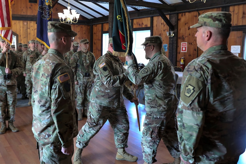 Lt. Col. Kevin Potts assumes command of the Fort Indiantown Gap National Guard Training Center, Pennsylvania Army National Guard, from Lt. Col. Andrew O’Connor at a change-of-command ceremony Nov. 19. Brig. Gen. James McCormack, assistant adjutant general-Army, presides while Command Sgt. Maj. Nicholas Lazor passes the unit colors to the outgoing commander. Fort Indiantown Gap, headquarters of the Pennsylvania National Guard, is the only live-fire, maneuver military training facility in Pennsylvania and is among the busiest National Guard Training Centers in the country. (U.S. Army National Guard photo by Sgt. 1st Class Zane Craig)