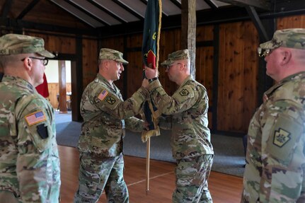 Brig. Gen. James McCormack, assistant adjutant general-Army, passes the colors to incoming commander Lt. Col. Kevin Potts during a change-of-command ceremony for the Fort Indiantown Gap National Guard Training Center, Nov. 19, 2022. Potts assumed command from Lt. Col. Andrew O’Connor. (U.S. Army National Guard photo by Sgt. 1st Class Zane Craig)