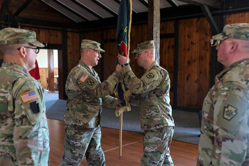 Brig. Gen. James McCormack, assistant adjutant general-Army, passes the colors to incoming commander Lt. Col. Kevin Potts during a change-of-command ceremony for the Fort Indiantown Gap National Guard Training Center, Nov. 19, 2022. Potts assumed command from Lt. Col. Andrew O’Connor. (U.S. Army National Guard photo by Sgt. 1st Class Zane Craig)