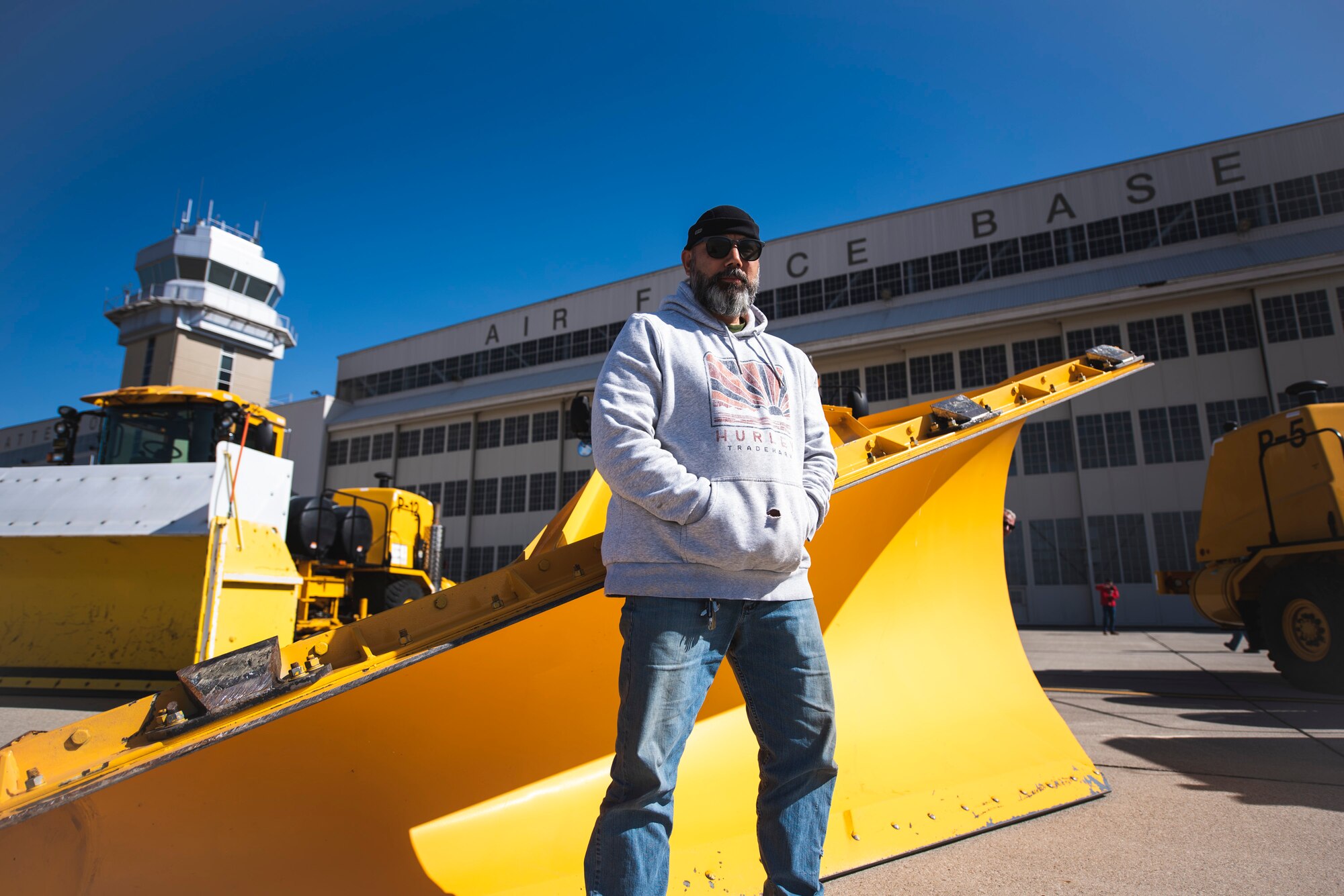 John Beimel, equipment operator for the 88th Civil Engineer Squadron’s Pavements, Equipment and Grounds Section, poses Oct. 14 in front of a snow-removal vehicle at Wright-Patterson Air Force Base, Ohio. The team is responsible for treating, maintaining, and clearing snow and ice from 120 miles of roads, 12.5 million square feet of parking lots, and 283,000 square feet of sidewalks, stairs and flightline. (U.S. Air Force photo by Hannah Carranza)