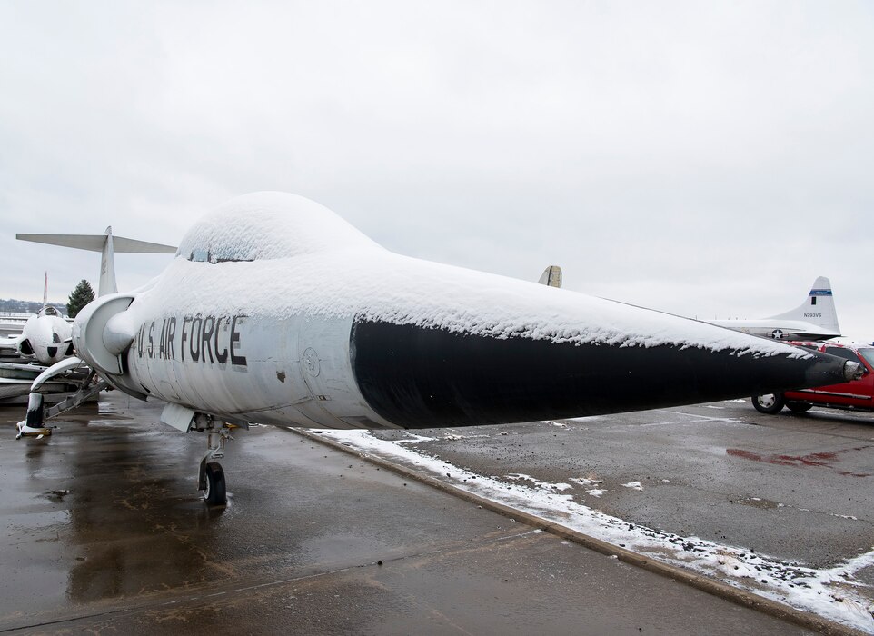 Snow lightly coats the fuselage of an F-104 Starfighter jet Dec. 1, 2020, outside a National Museum of the Air Force restoration hangar on Wright-Patterson Air Force Base. (U.S. Air Force photo by R.J. Oriez)