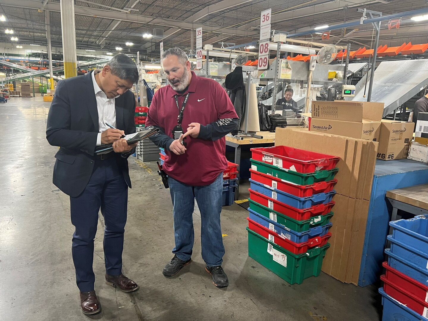 DDJC bin packing branch supervisor, Nicholas Kotta, explains a logistical process to Dr. 
Alejandro Hernandez during a tour on Nov. 16 at the DDJC installation in Tracy, California.