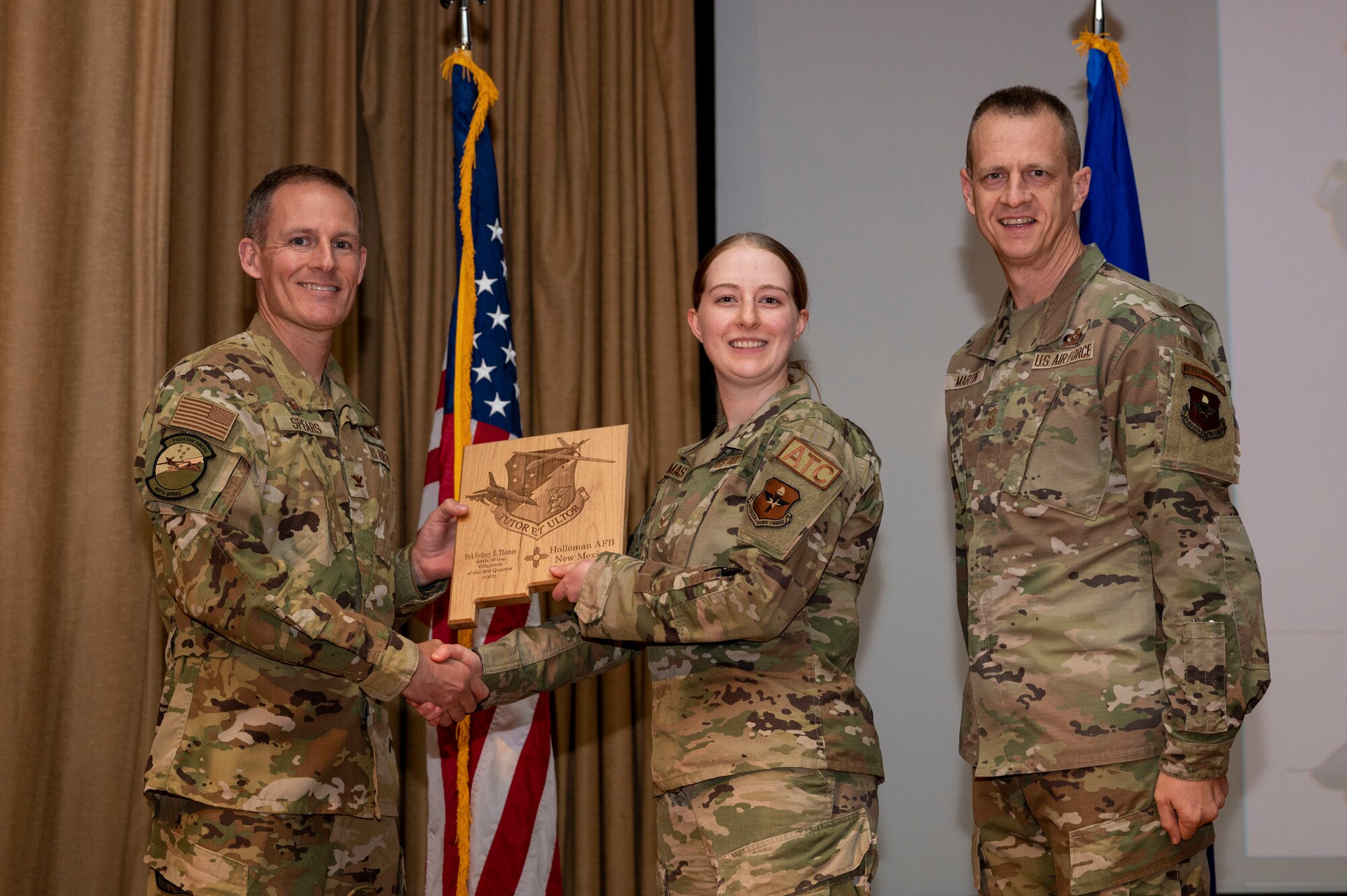 U.S. Air Force Senior Airman Sydney Thomas, from the 54th Operations Support Squadron, accepts the Volunteer of the Quarter Award, during the 49th Wing’s 3rd Quarter Award ceremony at Holloman Air Force Base, New Mexico, Nov. 21, 2022.