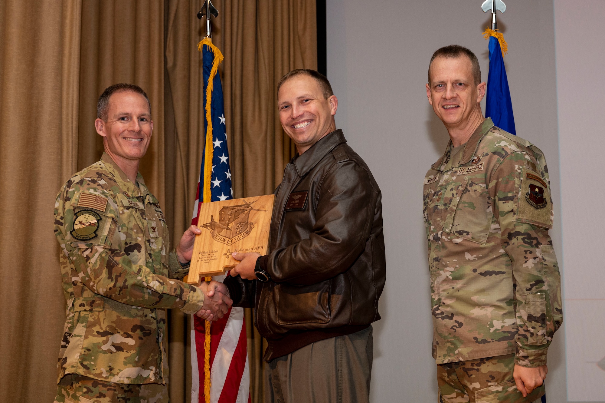 U.S. Air Force Maj. Sean Robere, from the 311th Fighter Squadron, accepts the Instructor Pilot of the Quarter Award, during the 49th Wing’s 3rd Quarter Award ceremony at Holloman Air Force Base, New Mexico, Nov. 21, 2022.
