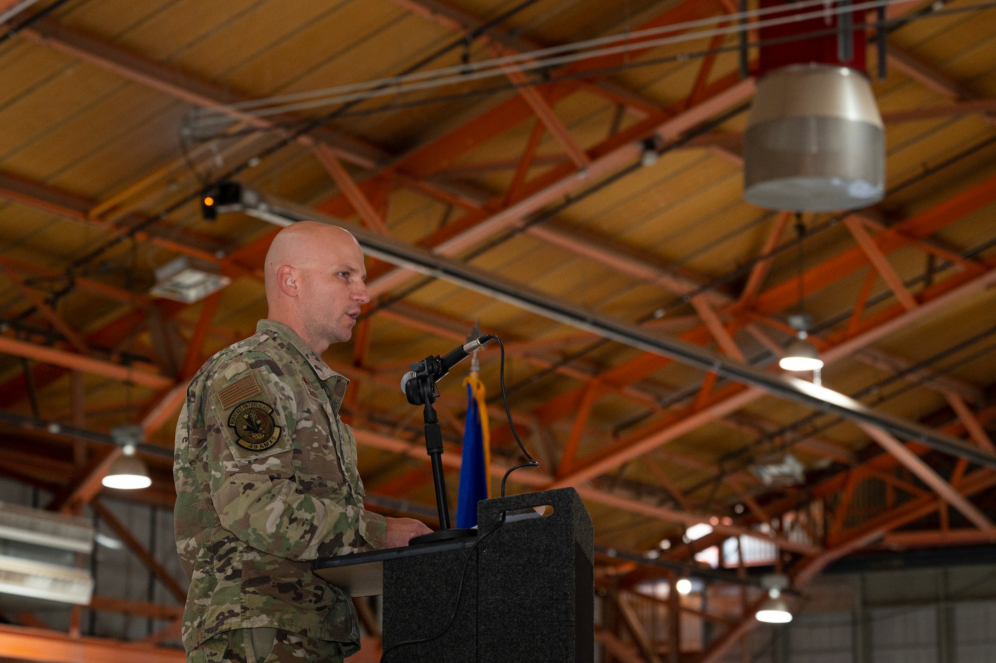 U.S. Air Force Maj. Donald Bolda, 49th Aircraft Maintenance Squadron commander, gives closing remarks during the 2022 Dedicated Crew Chief Appointment Ceremony at Holloman Air Force Base, New Mexico, Nov. 18, 2022. Dedicated Crew Chiefs must maintain aircraft in a combat ready status to ensure pilots and sensor operators can train to become a successful remotely piloted aircraft aircrew. (U.S. Air Force photo by Airman 1st Class Isaiah Pedrazzini)