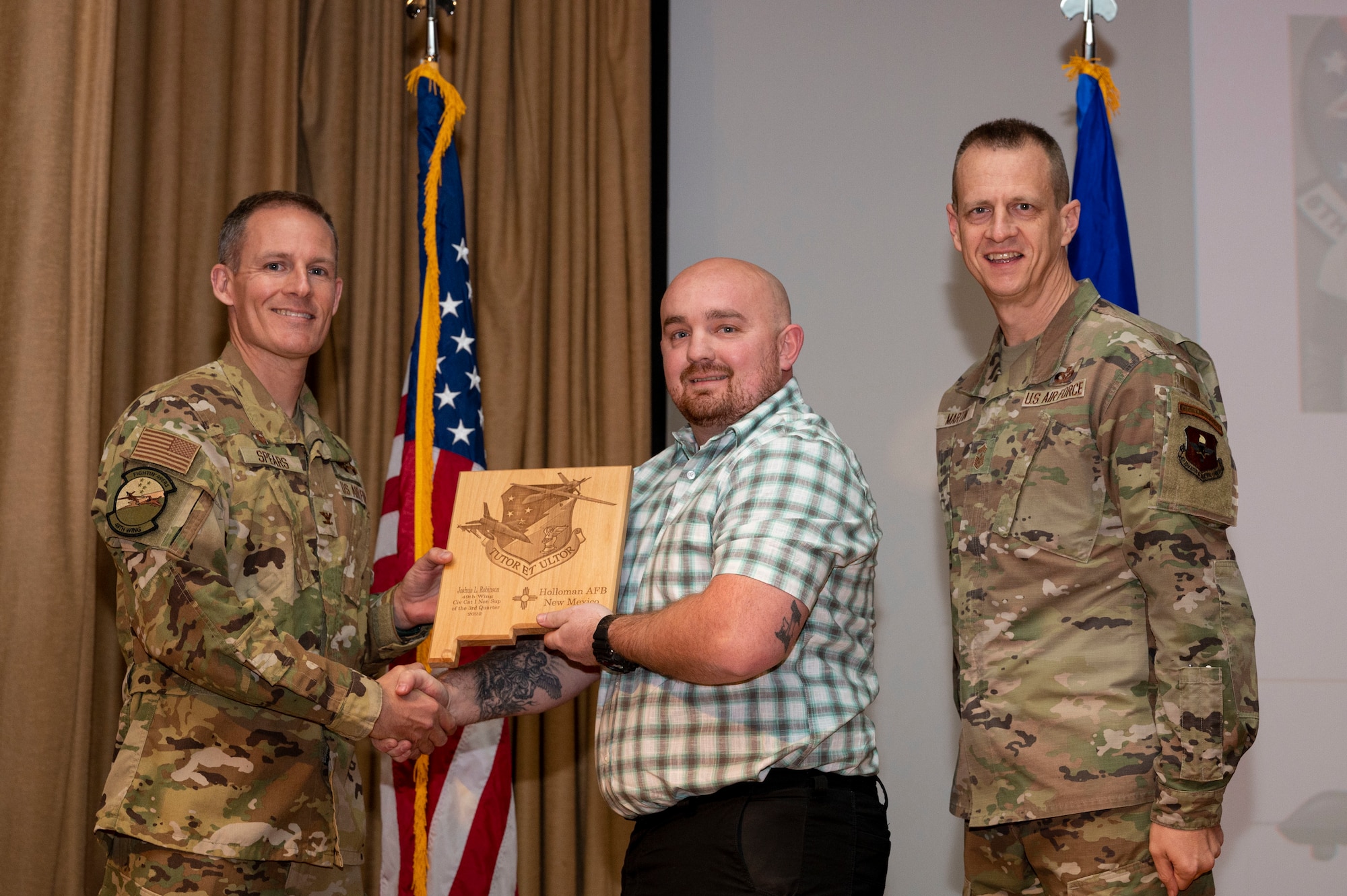 Joshua Robinson, from the 49th Equipment Maintenance Squadron, accepts the Civilian Category I (Non-supervisory) of the Quarter Award, during the 49th Wing’s 3rd Quarter Award ceremony at Holloman Air Force Base, New Mexico, Nov. 21, 2022.