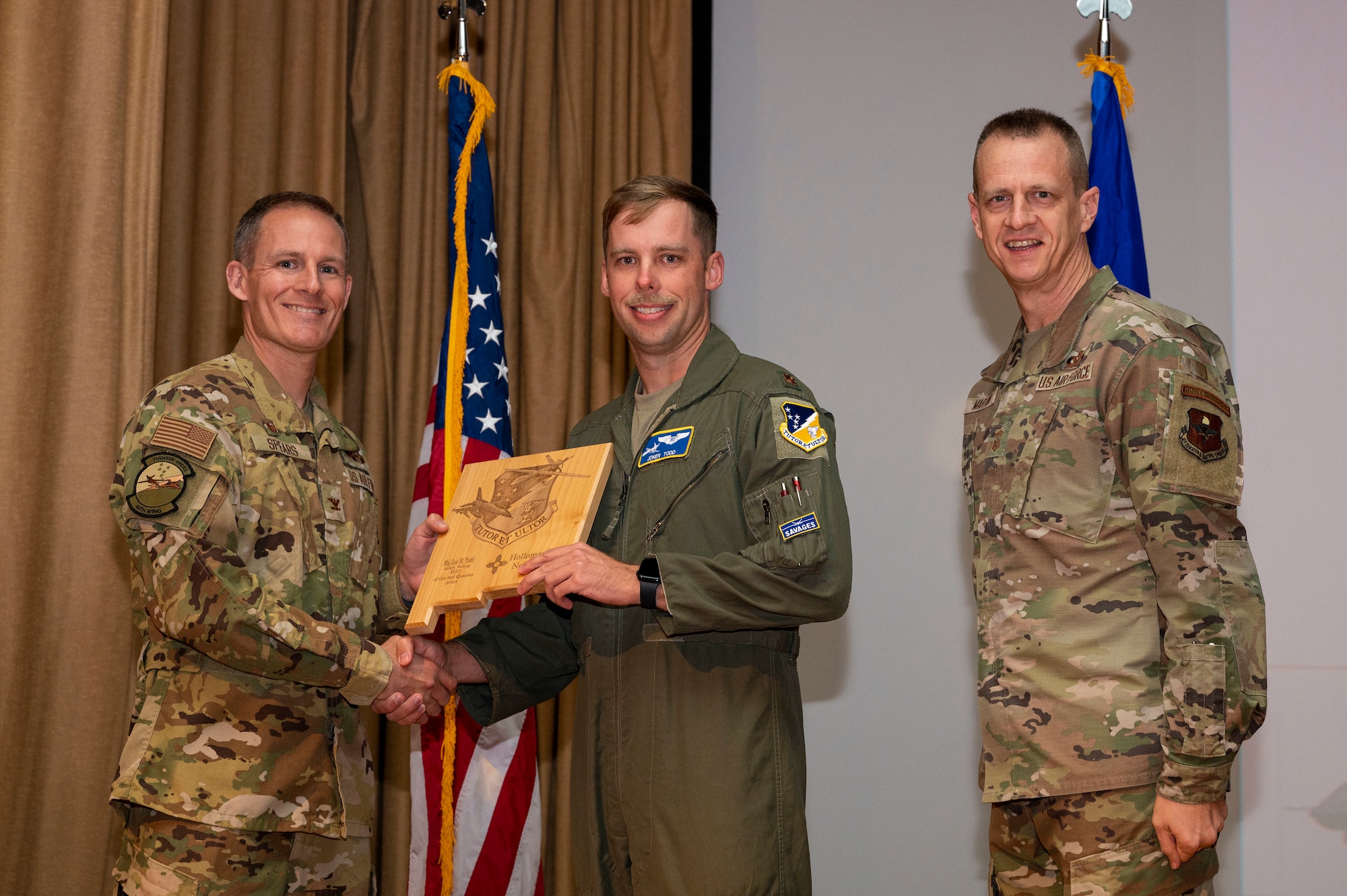 U.S. Air Force Maj. Lee Todd, from the 16th Training Squadron, accepts the Field Grade Officer of the Quarter Award, during the 49th Wing’s 3rd Quarter Award  ceremony at Holloman Air Force Base, New Mexico, Nov. 21, 2022.
