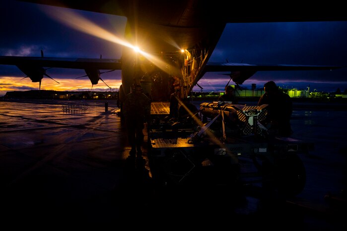 Airmen off load weapon.