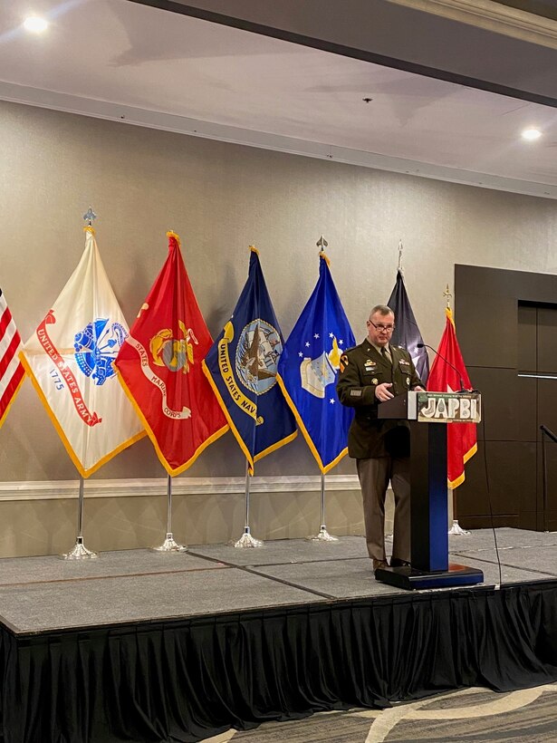 man in uniform speaks at podium
