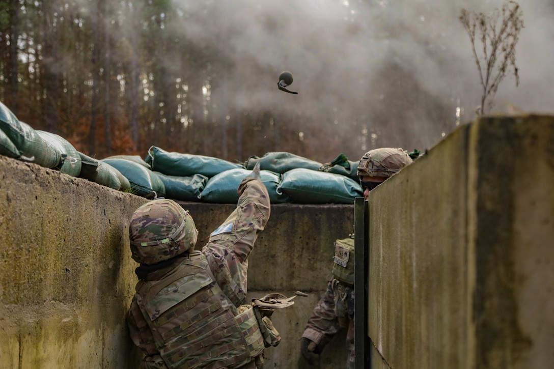 A soldier throws a grenade.