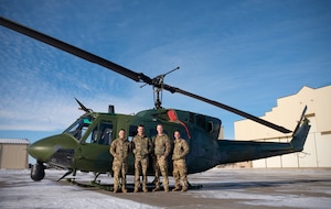 (From left to right) Capt. Jacques Soto, 40th Helicopter Squadron pilot, Capt. David Horney, 40 HS pilot, Senior Airman Stephen Rotton, 40 HS flight engineer, and Capt. Robert Lemme, 341st Healthcare Operational Medical Readiness Squadron flight surgeon, stand beside a UH-1N Huey helicopter on the flightline of Malmstrom Air Force Base, Mont., Nov. 18, 2022. Not shown is Senior Airman Timothy Woodruff, 40 HS flight engineer, who made up the fifth person of the aircrew responsible for saving an ailing man from his snow-bound home in Cascade, Mont., Nov. 13.  (U.S. Air Force Photo by Staff Sgt. Elora J. McCutcheon)