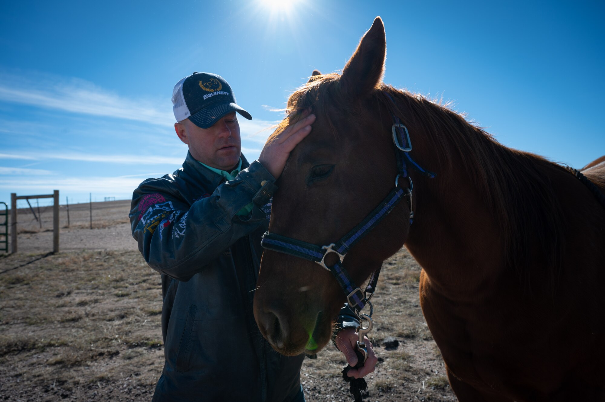 A chief poses with his horse, Gunner.