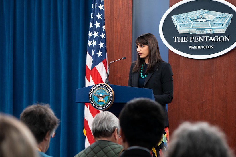 Deputy Pentagon Press Secretary Sabrina Singh speaks to reporters from a podium with the Pentagon sign and an American flag backdrop.