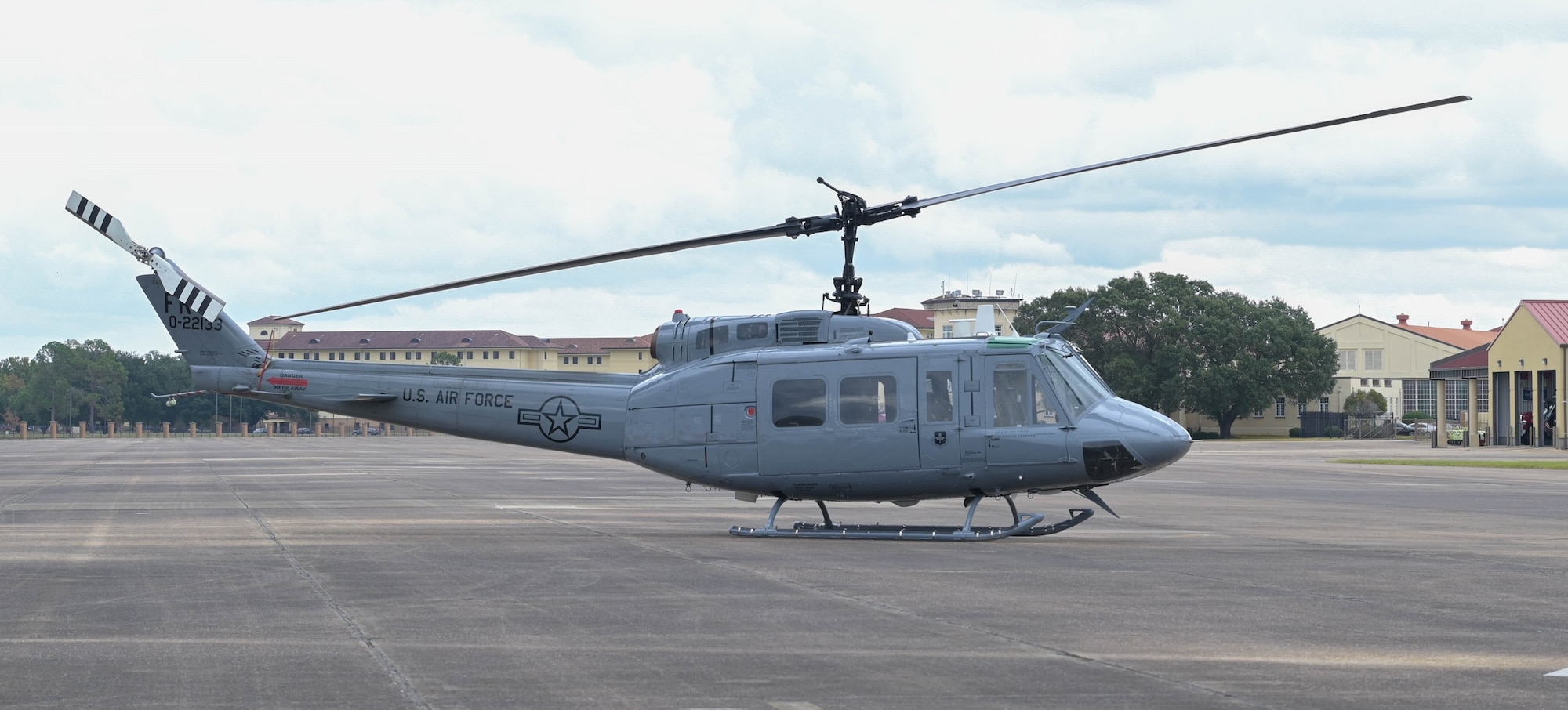 helicopter sits on a flight line