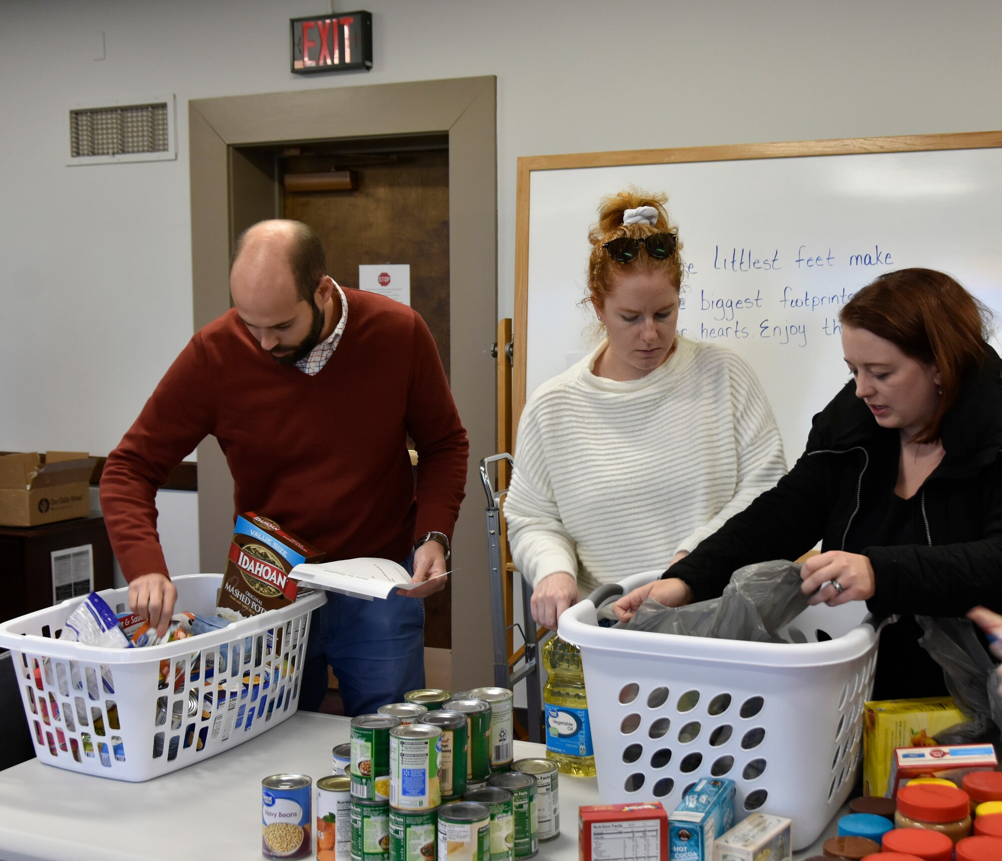 Arnold Engineering Development Complex team members, from left, Paul Ritter, Nicole Prieto and Rachel Garrard sort food items.