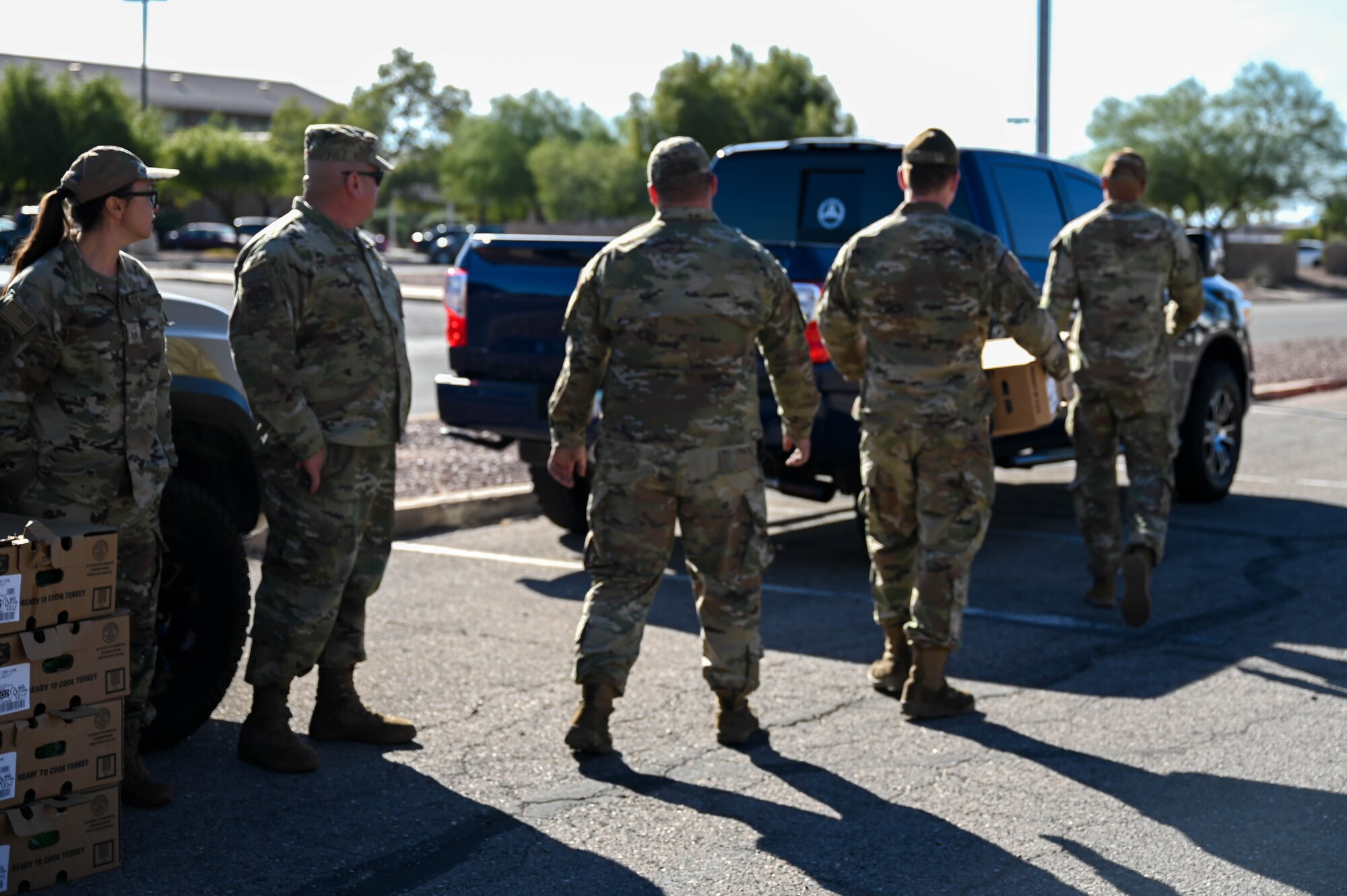 A photo of military members distributing turkeys during a turkey drive.