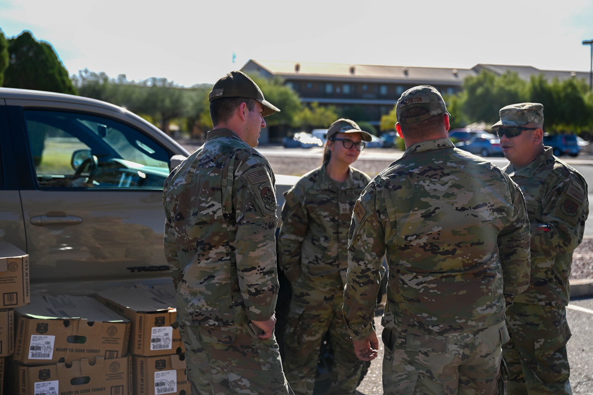 A photo of military members distributing turkeys during a turkey drive.