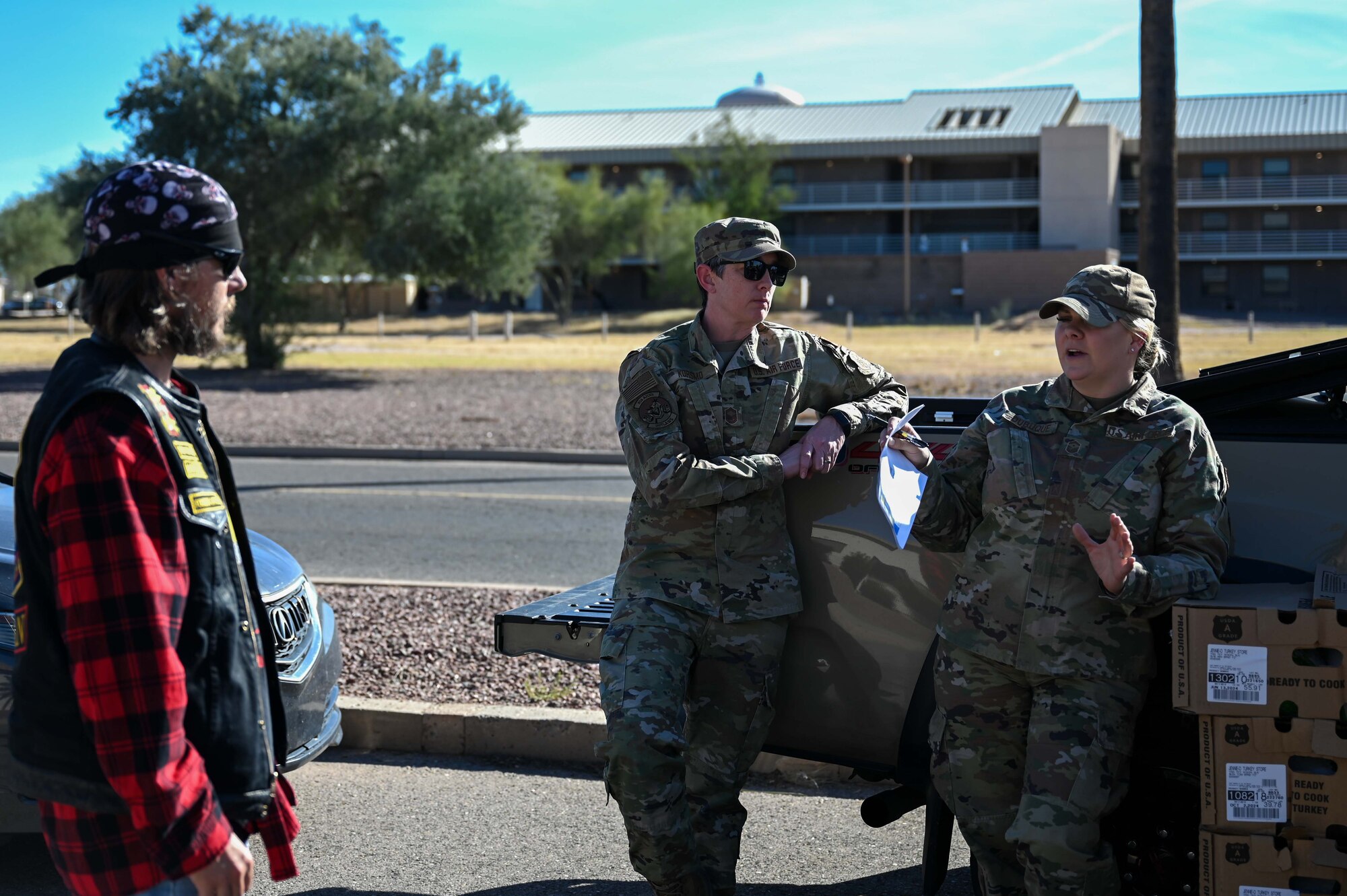 A photo of military members distributing turkeys during a turkey drive.
