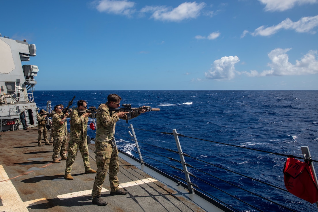 U.S. Soldiers assigned to the 2nd Battalion, 1st Special Forces Group (Airborne) prepare for JPMRC 23- 01 aboard the Guided-Missel Destroyer USS Hopper (DDG 70) near Oahu, Hawaii, Oct. 25, 2022. U.S.S. Hopper and crew are participating in Joint Pacific Multinational Readiness Center (JPMRC) rotation 23-01, alongside the 25th Infantry Division, and elements from the 1st Special Forces Group (Airborne). JPMRC rotations allow Army forces to rehearse strategic movements and maneuvers, integrate with allies and partners, and increase the readiness of the Joint Force in the Indo-Pacific region. (U.S. Army photo by Staff Sgt. Miguel Peña)