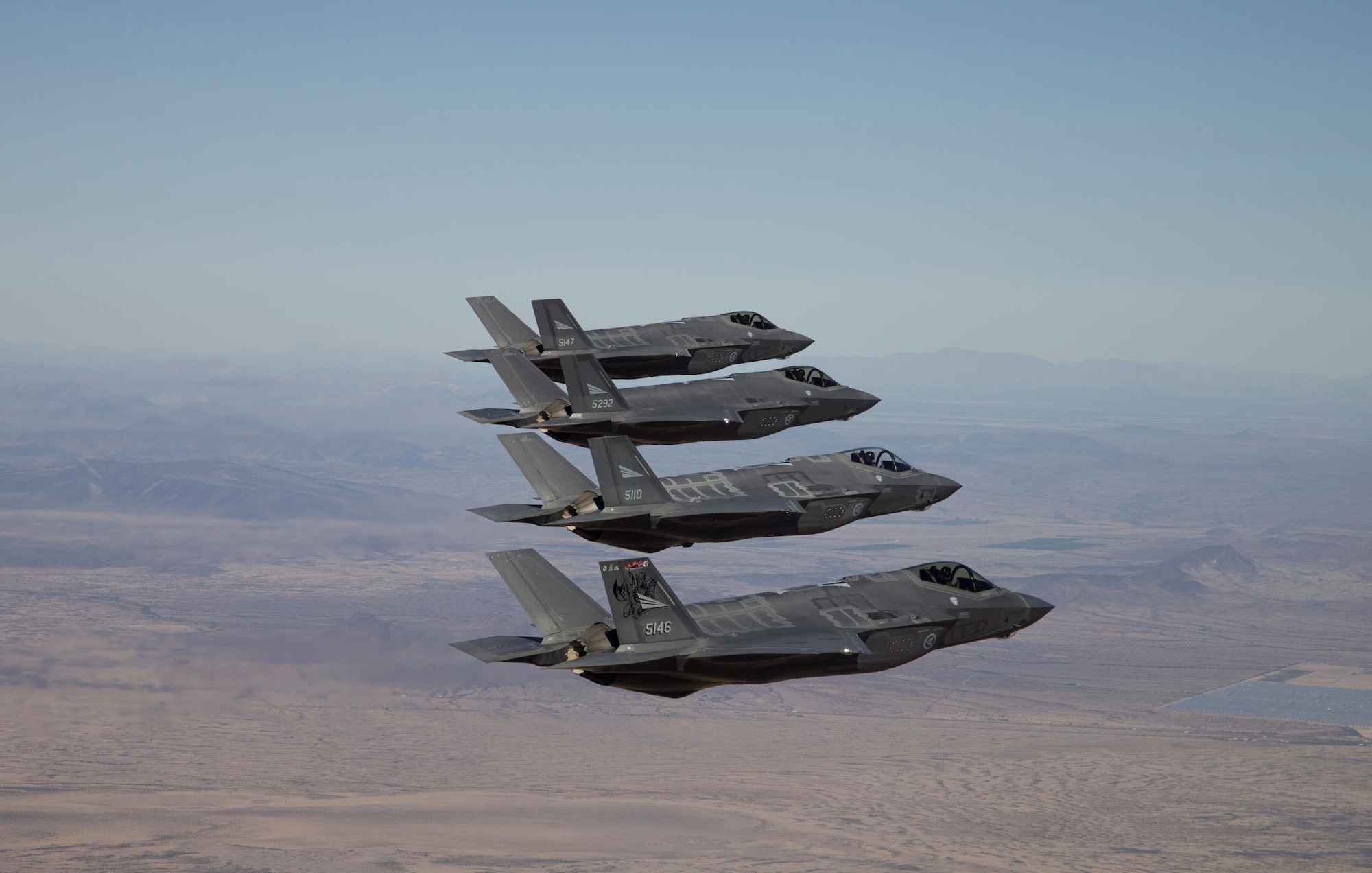 Four Royal Norwegian Air Force F-35 Lightning II aircraft fly in formation.