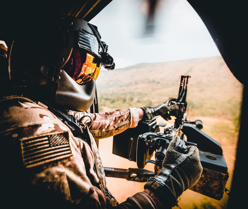 A UH-60 Black Hawk helicopter crew chief, assigned to 2nd Battalion, 25th Combat Aviation Brigade, clears his M240L medium machine gun after engaging several ground targets as part of an aerial gunnery during Hanuman Guardian 22, Lop Buri, Kingdom of Thailand, Mar. 16, 2022. Working together, the U.S. Army and the Royal Thai Army conduct multinational, combined task force events that are vital to maintaining the readiness and interoperability of security forces across the region. (U.S. Army photo by Staff Sgt. Timothy Hamlin)