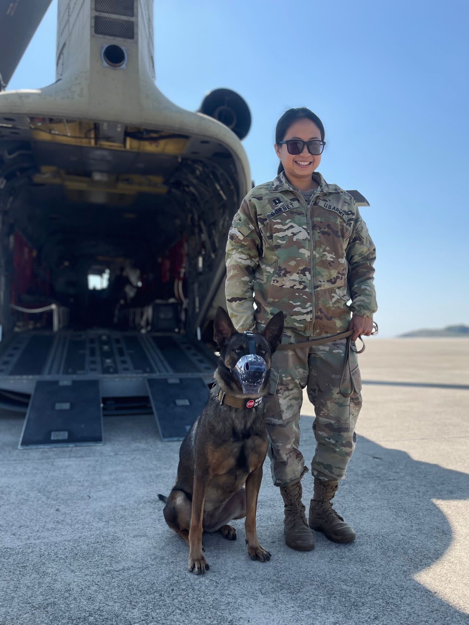 U.S. Army Capt. Denise Sorbet, 106th Medical Detachment Veterinary Service Support (MDVSS) Team II officer in charge, pauses for a photo with a military working dog. The MDVSS Team II recently relocated from Camp Humphreys to Kunsan Air Base, Republic of Korea. (Courtesy Photo)