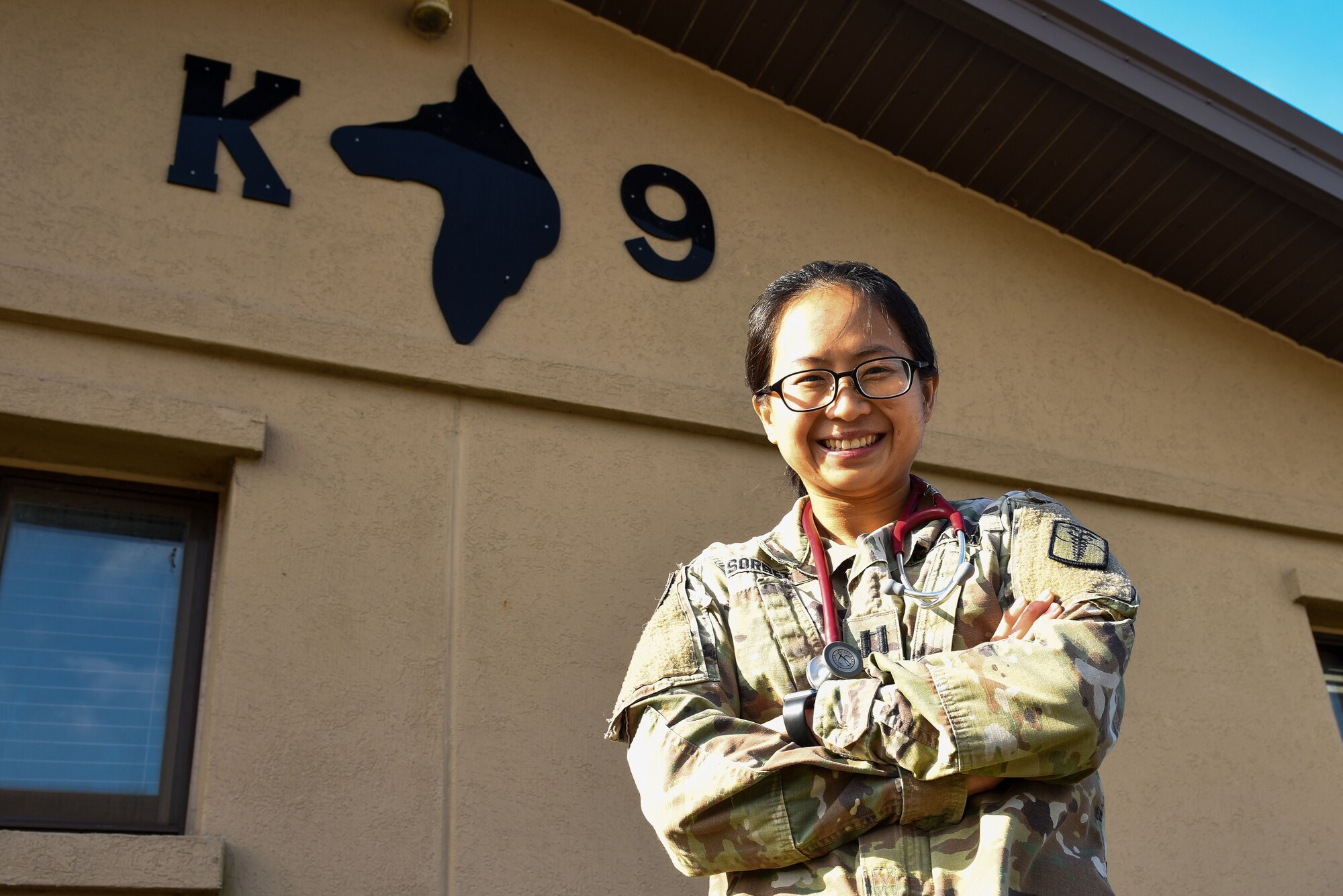 U.S. Army Capt. Denise Sorbet, 106th Medical Detachment Veterinary Service Support Team II officer in charge, pauses for a photo outside the military working dog kennel at Kunsan Air Base, Republic of Korea, Nov. 16, 2022. In addition to providing routine healthcare to MWDs, Sorbet and her team conduct commercial audits and inspections of food facilities. (U.S. Air Force photo by Tech. Sgt. Timothy Dischinat)