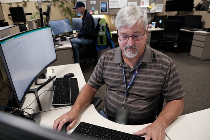 two men working on computers
