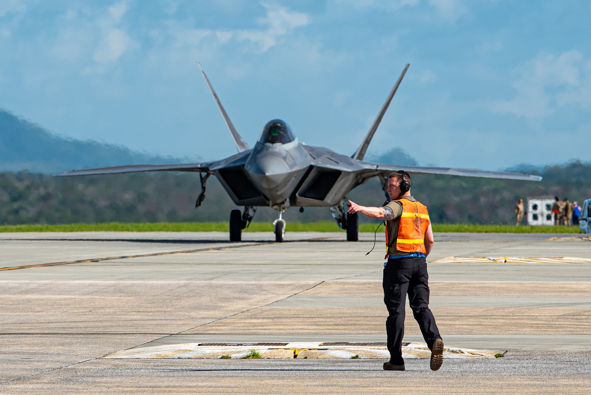 An Airman directs a jet.