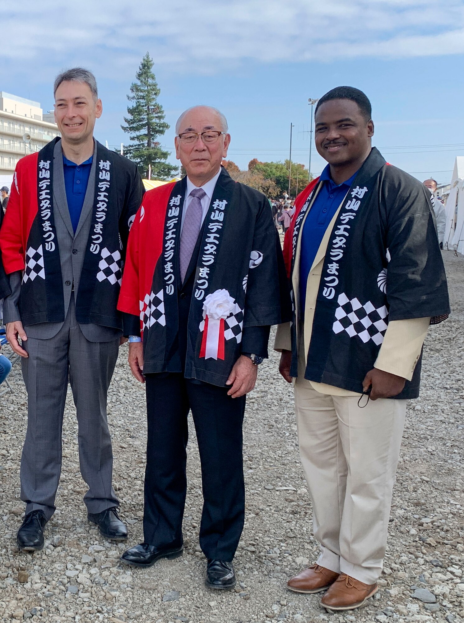 U.S. Air Force Col. Andrew Roddan (left) 374th Airlift Wing commander, poses for a group photo with Yasuhiro Yamazaki Musashimurayama mayor, and Chief Master Sgt. Jerry Dunn (right) 374th Airlift Wing command chief at the Deedara Festival,