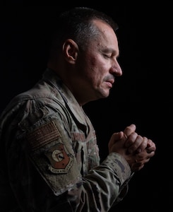 Chaplain (Capt.) Yury Volkovinsky, 512th Airlift Wing chaplain, holds his hands in prayer at Dover Air Force Base, Delaware, Nov. 4, 2022. Volkovinsky has prayed for his family in Ukraine every day since the beginning of the Russian invasion of Ukraine and holds strong to his belief that better days are to come for the Ukrainian people. (U.S. Air Force photo by Senior Airman Cydney Lee)