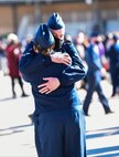 Airmen First Class Melissa McCabe and Alex Waters see each other for the first time and share a hug after completing Basic Miliary Training at Lackland Air Force Base, Texas. (U.S. Air National Guard courtesy photo)