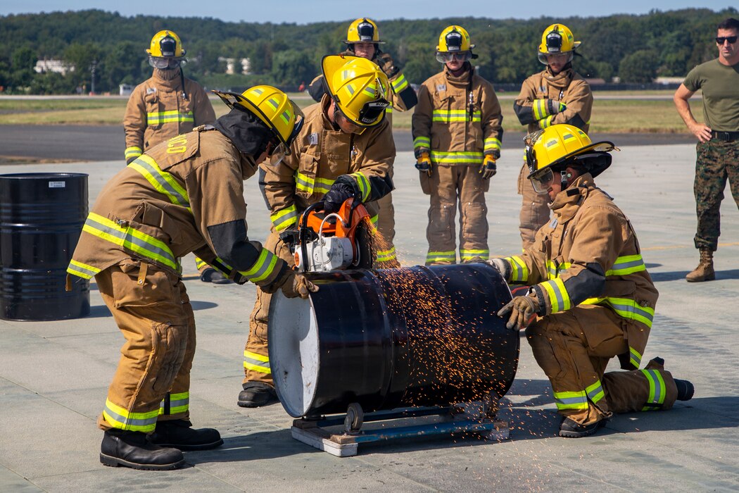 U.S. Marines with Marine Corps Air Facility Quantico and Chemical Biological Incident Response Force from Indian Head, Maryland participate in the Rescue Saw Cutting Race for the Aircraft Rescue and Fire Fighter Rodeo at MCAF on Marine Corps Base Quantico, Sep. 2, 2022. The ARFF Rodeo is a competition for Marines to showcase their operational knowledge of firefighting tactics, techniques, and procedures. (U.S. Marine Corps Photo by Lance Cpl. George Nudo)