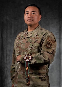 Airman poses with traditional Indigenous jewelry.