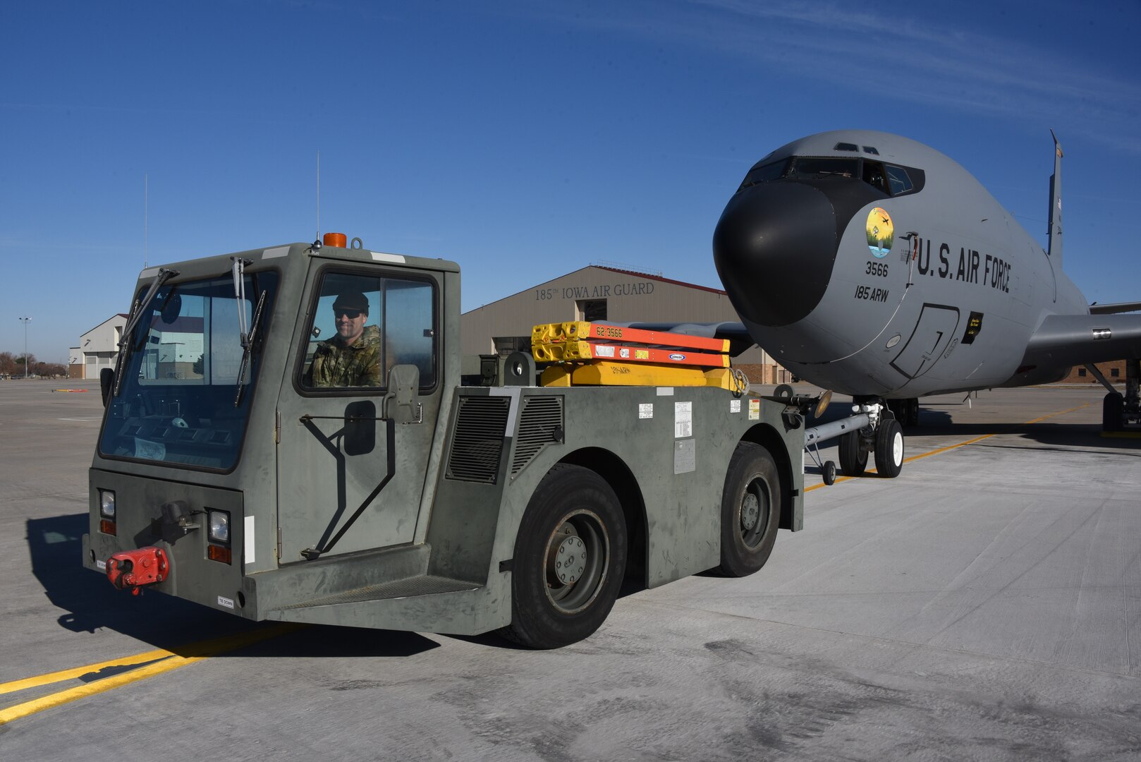 Master Sgt. Jamie Bethune tows a U.S. Air Force KC-135 Stratotanker, assigned to the Iowa Air National Guard’s 185th Air Refueling Wing, on the ramp in Sioux City, Iowa, Nov. 22, 2022. The unit’s aircraft returned to Sioux City this week after operating from Topeka, Kansas, during a runway construction project.