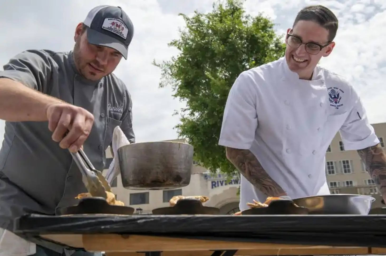 Chief Petty Officer James Henson, a culinary specialist and executive aide to the Coast Guard District Eight commander, prepares a seafood dish in New Orleans on April 20, 2022. Henson participated in a cajun seafood cook-off partnered with a local chef as part of New Orleans Navy Week 2022. (U.S. Coast Guard photo by Petty Officer 3rd Class Gabriel Wisdom)