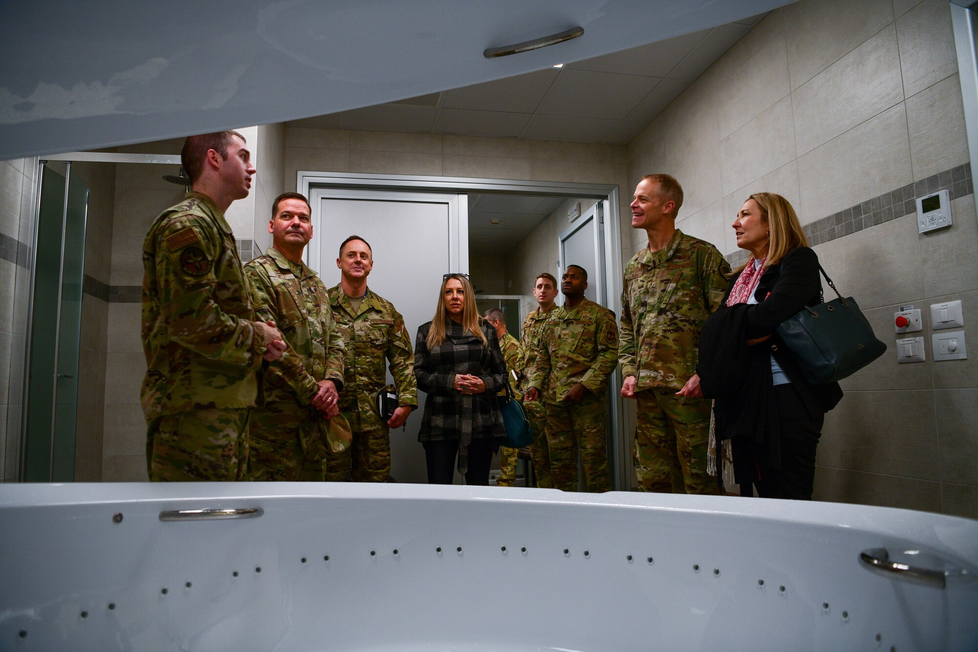 U.S. Air Force Maj. Gen. Derek France, Third Air Force commander, right, and his spouse Mrs. Amanda France, are briefed on the float pod inside of the 31st Medical Group Comprehensive Operational Medicine for Battle Ready Airmen clinic at Aviano Air Base, Italy, Nov. 22, 2022. The clinic houses rehabilitation equipment, such as gait retraining software, anti-gravity treadmills for rehab, recovery modalities and a float pod for sensory deprivation. (U.S. Air Force photo by Senior Airman Brooke Moeder)