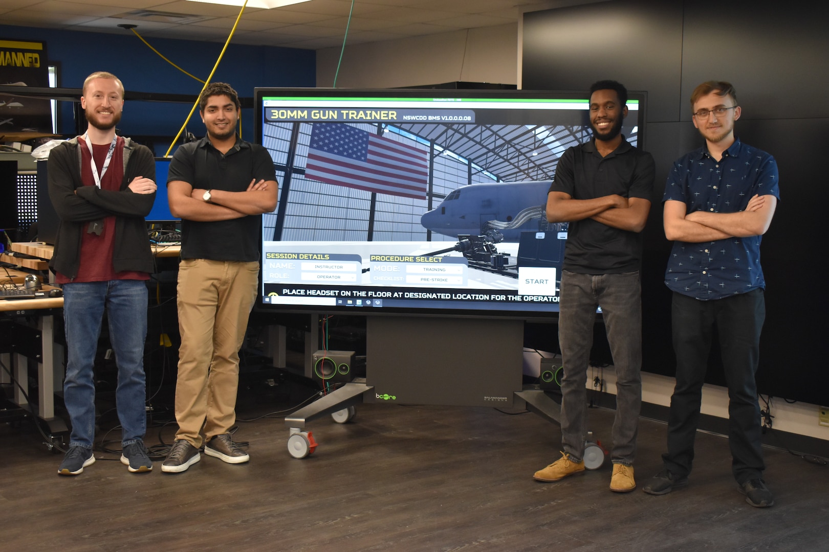 IMAGE: Brendan Dolata, Amit Nemani, Brandon Gipson and Devon Oberdan are all computer scientists at NSWC Dahlgren Division, working on the virtual reality (VR)-based applications in the Battle Management System (BMS). The team works with Mike Weisman (not pictured), BMS Metrology and Augmented Reality/VR Project Lead, to implement the backend development on the application.