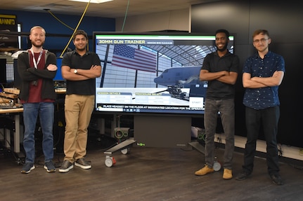 IMAGE: Brendan Dolata, Amit Nemani, Brandon Gipson and Devon Oberdan are all computer scientists at NSWC Dahlgren Division, working on the virtual reality (VR)-based applications in the Battle Management System (BMS). The team works with Mike Weisman (not pictured), BMS Metrology and Augmented Reality/VR Project Lead, to implement the backend development on the application.