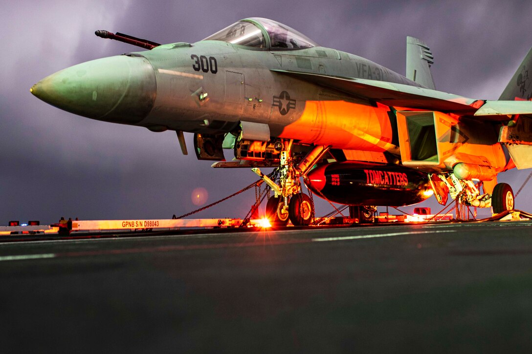 An F/A-18E Super Hornet is chocked and chained on the USS Gerald R. Ford.