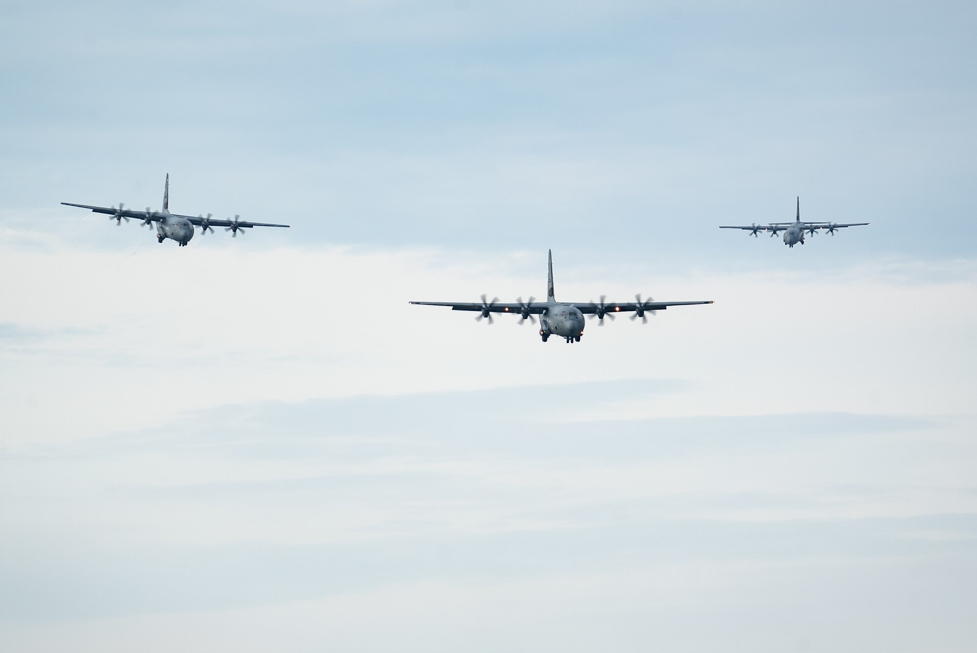 Three U.S. Air Force C-130J Super Hercules assigned to the 317th Airlift Wing at Dyess Air Force Base, Texas, approach the flight line during RED FLAG-Alaska 23-1 on Joint Base Elmendorf-Richardson, Alaska, Oct. 14, 2022. This exercise provides unique opportunities to integrate various forces into joint, coalition and multilateral training from simulated forward operating bases. (U.S. Air Force photo by Airman 1st Class J. Michael Peña)