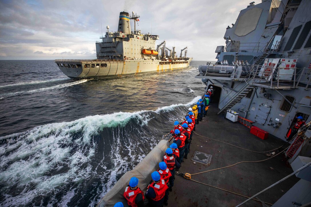 Two ships conduct a replenishment-at-sea.